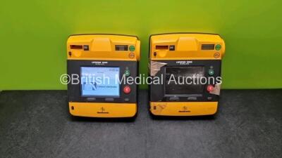 2 x Medtronic Physio Control Lifepak 1000 Defibrillators *Mfd 2009* (1 x No Power, 1 x Powers Up with Stock Battery Stock Battery Not Included, Both with Damage to Casing and Screen- See Photos)