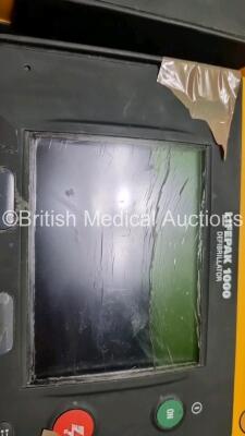 2 x Medtronic Physio Control Lifepak 1000 Defibrillators *Mfd 2009* (1 x No Power, 1 x Powers Up with Stock Battery Stock Battery Not Included, Both with Damage to Casing and Screen- See Photos) - 7