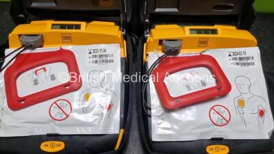 2 x Physio Control Lifepak CR Plus Defibrillators *Mfd 2016 / 2016* with 2 x Electrode Pads *Both in Date* and 2 x Res-Cue Masks in 2 x Carry Cases - 2