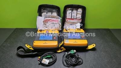 2 x Medtronic Physio Control Lifepak 1000 Defibrillators *Mfd 2008 / 2010* (Both Power Up 1 x With Crack In Screen - See Photo) with 2 x 3 Lead ECG Leads, 2 x In Date Electrode Packs and 2 x Batteries *Install Before 2022 / 2023*