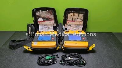 2 x Medtronic Physio Control Lifepak 1000 Defibrillators *Mfd 2008 / 2016* (Both Power Up, 1 x with Slight Crack In Casing - See Photo) with 2 x 3 Lead ECG Leads, 2 x In Date Electrode Packs and 2 x Batteries *Install Before 20242026*