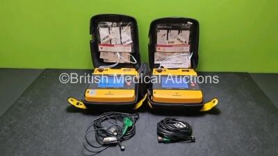 2 x Medtronic Physio Control Lifepak 1000 Defibrillators *Mfd 2007 / 2010* (Both Power Up 1 x with Slight Crack In Casing - See Photo) with 2 x 3 Lead ECG Leads, 2 x In Date Electrode Packs and 2 x Batteries *Install Before 2024 / 2027*