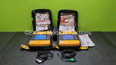 2 x Medtronic Physio Control Lifepak 1000 Defibrillators *Mfd 2008 / 2012* (Both Power Up, 1 x Slight Crack In Casing - See Photo) with 2 x 3 Lead ECG Leads, 2 x In Date Electrode Packs and 2 x Batteries *Install Before 2024*