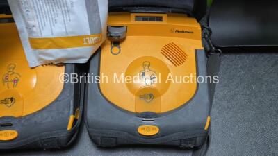 2 x Medtronic Lifepak CR Plus Defibrillators (Both Power Up) with 2 x Electrode Packs *Both in Date* in Carry Cases and 2 x Medtronic Mounting Brackets - 2