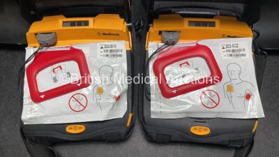 2 x Medtronic Lifepak CR Plus Defibrillators (Both Power Up) with 2 x Electrode Packs *Both in Date* in Carry Cases and 2 x Medtronic Mounting Brackets - 4