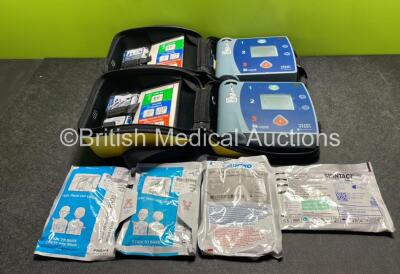 2 x Laerdal Heartstart FR2+ Defibrillators with 4 x Batteries and 4 x Electrode Packs *2 in Date, 2 Expired* in Carry Cases (Both Power Up)