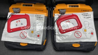 2 x Medtronic Lifepak CR Plus Defibrillators (Both Power Up) with 2 x Electrode Packs *Both Expired* in Carry Cases and 2 x Medtronic Mounting Brackets - 4