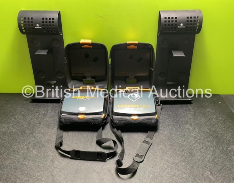 2 x Medtronic Lifepak CR Plus Defibrillators (Both Power Up) with 2 x Electrode Packs *1 x in Date, 1 x Expired* in Carry Cases and 2 x Medtronic Mounting Brackets