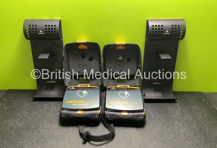 2 x Medtronic Lifepak CR Plus Defibrillators (Both Power Up) with 2 x Electrode Packs *Both Expired* in Carry Cases and 2 x Medtronic Mounting Brackets