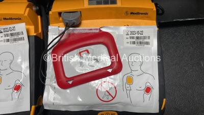 2 x Medtronic Lifepak CR Plus Defibrillators (Both Power Up) with 2 x Electrode Packs *Both Expired* in Carry Cases and 2 x Medtronic Mounting Brackets - 4