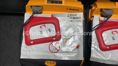 2 x Medtronic Lifepak CR Plus Defibrillators (Both Power Up) with 2 x Electrode Packs *Both Expired* in Carry Cases and 2 x Medtronic Mounting Brackets - 5