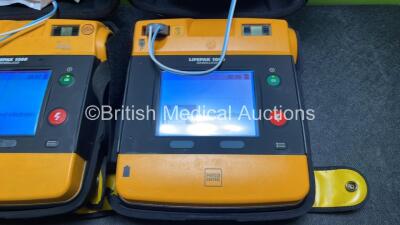 2 x Medtronic Physio Control Lifepak 1000 Defibrillators (Both Power Up with Cracks in Casing - See Photos) with 2 x 3 Lead ECG Leads, 3 x Electrode Packs (All in Date) and 2 x Batteries *Install Before 2024 / 2024* - 4