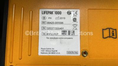 2 x Medtronic Physio Control Lifepak 1000 Defibrillators (Both Power Up with Cracks in Casing - See Photos) with 2 x 3 Lead ECG Leads, 3 x Electrode Packs (All in Date) and 2 x Batteries *Install Before 2024 / 2024* - 12