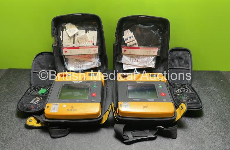 2 x Medtronic Physio Control Lifepak 1000 Defibrillators (Both Power Up with Cracks in Casing - See Photos) with 2 x 3 Lead ECG Leads, 3 x Electrode Packs (All in Date) and 2 x Batteries *Install Before 2024 / 2024*