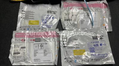 2 x Medtronic Physio Control Lifepak 1000 Defibrillators (Both Power Up with Cracks in Casing - See Photos) with 2 x 3 Lead ECG Leads, 4 x Electrode Packs (3 in Date, 1 x Expired) and 2 x Batteries *Install Before 2022 / 2025* - 3