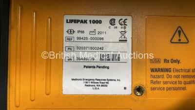 2 x Medtronic Physio Control Lifepak 1000 Defibrillators (Both Power Up with Cracks in Casing - See Photos) with 2 x 3 Lead ECG Leads, 4 x Electrode Packs (All in Date) and 2 x Batteries *Install Before 2022 / 2025* - 10