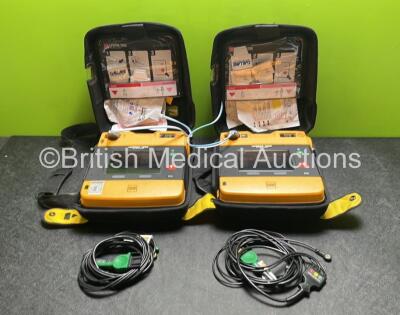 2 x Medtronic Physio Control Lifepak 1000 Defibrillators (Both Power Up with Cracks in Casing - See Photos ) with 2 x 3 Lead ECG Leads, 4 x Electrode Packs (All in Date) and 2 x Batteries *Install Before 2023 / 2024*