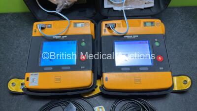 2 x Medtronic Physio Control Lifepak 1000 Defibrillators (Both Power Up with Cracks in Casing - See Photos ) with 2 x 3 Lead ECG Leads, 4 x Electrode Packs (All in Date) and 2 x Batteries *Install Before 2024 / 2024* - 2