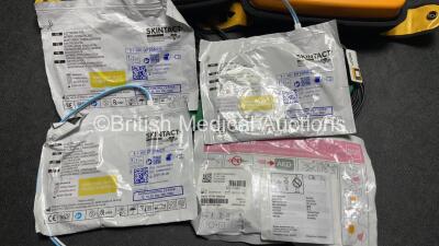 2 x Medtronic Physio Control Lifepak 1000 Defibrillators (Both Power Up with Cracks in Casing - See Photos ) with 2 x 3 Lead ECG Leads, 4 x Electrode Packs (All in Date) and 2 x Batteries *Install Before 2024 / 2024* - 7