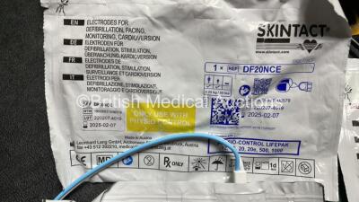 2 x Medtronic Physio Control Lifepak 1000 Defibrillators (Both Power Up with Cracks in Casing - See Photos ) with 2 x 3 Lead ECG Leads, 4 x Electrode Packs (All in Date) and 2 x Batteries *Install Before 2024 / 2024* - 8