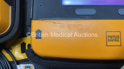 2 x Medtronic Physio Control Lifepak 1000 Defibrillators (Both Power Up with Cracks in Casing - See Photos ) with 2 x 3 Lead ECG Leads, 4 x Electrode Packs (All in Date) and 2 x Batteries *Install Before 2024 / 2024* - 11