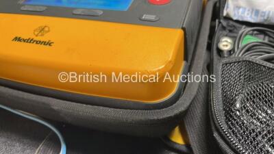 2 x Medtronic Physio Control Lifepak 1000 Defibrillators (Both Power Up, 1 x Small Crack in Casing, 1 x Slight Damage to Casing - See Photos ) with 2 x 3 Lead ECG Leads, 4 x Electrode Packs (All in Date) and 2 x Batteries *Install Before 2028 / 2024* - 6