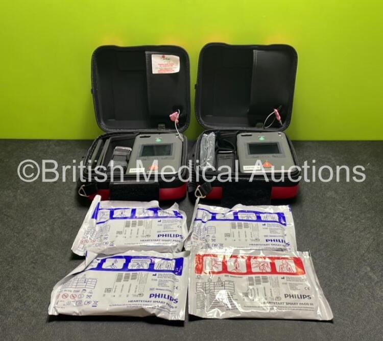 2 x Philips Heartstart FR3 Defibrillators (Both Power Up) In Carry Cases with 4 x Electrode Packs (All in Date) and 2 x Batteries (Install Before 2028 / 2028) *SN C18B-00114 / C18B-00104*