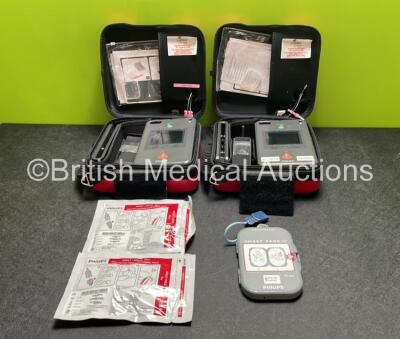 2 x Philips Heartstart FR3 Defibrillators (Both Power Up) In Carry Cases with 3 x Electrode Packs (All in Date) and 2 x Batteries (Install Before 2028 / 2028) *SN C18A-00370 / C18B-00315*