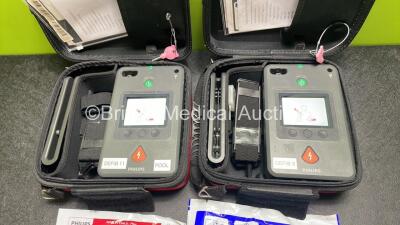 2 x Philips Heartstart FR3 Defibrillators (Both Power Up) In Carry Cases with 4 x Electrode Packs (2 in Date, 2 Expired) and 2 x Batteries (Install Before 2028 / 2028) *SN C18B-00285 / C18B-00084* - 2