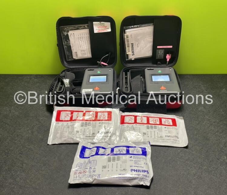 2 x Philips Heartstart FR3 Defibrillators (Both Power Up) In Carry Cases with 3 x Electrode Packs (All in Date) and 2 x Batteries (Install Before 2028 / 2025) *SN C18B-00081 / C16A-00271*