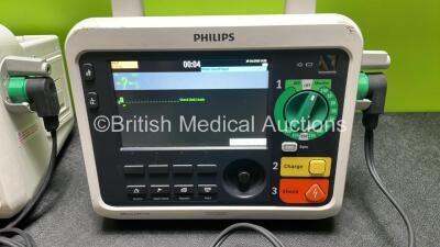 2 x Philips Efficia DFM100 Defibrillator *Mfd 2018 / 2018* with ECG and Printer Options, 2 x Batteries, 2 x Paddle Leads and 1 x 3 Lead ECG Lead (Both Power Up) *SN NA / CN32618885* - 2