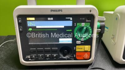 2 x Philips Efficia DFM100 Defibrillator *Mfd 2018 / 2018* with ECG and Printer Options, 2 x Batteries, 2 x Paddle Leads and 1 x 3 Lead ECG Lead (Both Power Up) *SN NA / CN32618885* - 3