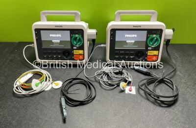 2 x Philips Efficia DFM100 Defibrillator *Mfd 2018 / 2020* with ECG and Printer Options, 2 x Batteries, 2 x Paddle Leads and 2 x 3 Lead ECG Leads (Both Power Up) *SN CN CN32639900 / CN32618883*