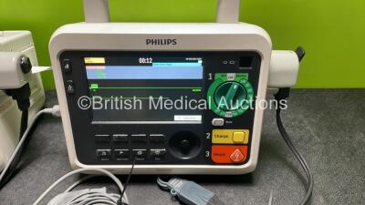 2 x Philips Efficia DFM100 Defibrillator *Mfd 2018 / 2020* with ECG and Printer Options, 2 x Batteries, 2 x Paddle Leads and 2 x 3 Lead ECG Leads (Both Power Up) *SN CN CN32639900 / CN32618883* - 3