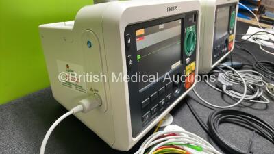 2 x Philips Efficia DFM100 Defibrillator *Mfd 2018 / 2020* with ECG and Printer Options, 2 x Batteries, 2 x Paddle Leads and 2 x 3 Lead ECG Leads (Both Power Up) *SN CN CN32639900 / CN32618883* - 5