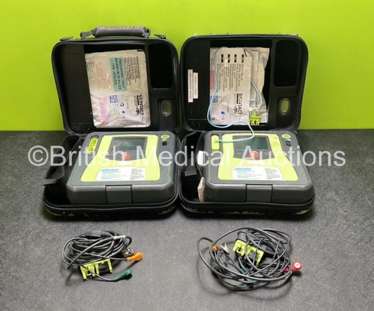 2 x Zoll AED PRO Defibrillators (Both Power Up) with 2 x 3 Lead ECG Leads, 2 x Batteries and 4 x Electrode Packs (3 x in Date, 1 x Expired)