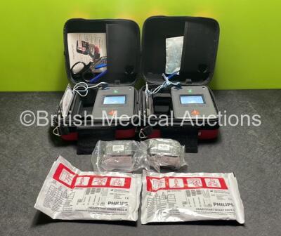 2 x Philips Heartstart FR3 Defibrillators (Both Power Up) In Carry Cases with 2 x Electrode Packs (Both in Date) and 4 x Batteries (Install Before 2026 / 2026 / 2022 / 2023)