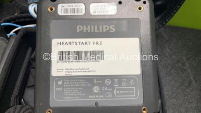 2 x Philips Heartstart FR3 Defibrillators (Both Power Up) In Carry Cases with 2 x Electrode Packs (1 in Date, 1 Expired) and 4 x Batteries (Install Before 2026 / 2028 / 2022 / 2023) - 10