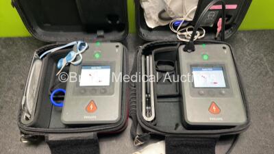 2 x Philips Heartstart FR3 Defibrillators (Both Power Up) In Carry Cases with 4 x Batteries (Install Before NA / 2023 / 2022 / 2023) and Laerdal ShockLink Box - 2