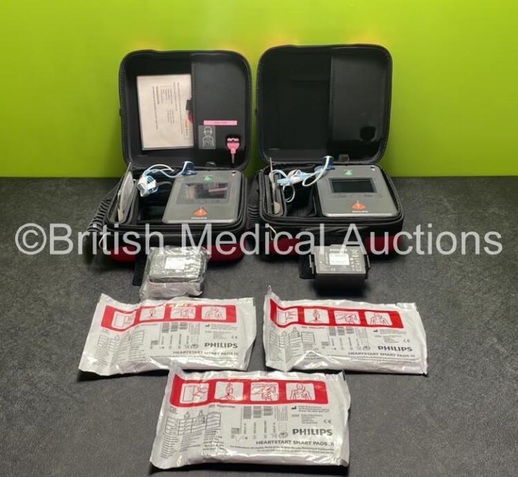 2 x Philips Heartstart FR3 Defibrillators (Both Power Up) In Carry Cases with 3 x Electrode Packs (All in Date) and 4 x Batteries (Install Before 2028 / 2028 / 2027 / 2025)