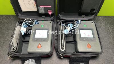 2 x Philips Heartstart FR3 Defibrillators (Both Power Up) In Carry Cases with 3 x Electrode Packs (All in Date) and 4 x Batteries (Install Before 2028 / 2028 / 2027 / 2025) - 2