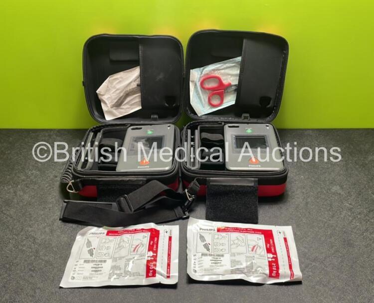 2 x Philips Heartstart FR3 Defibrillators (Both Power Up) In Carry Cases with 2 x Electrode Packs (Both in Date) and 2 x Batteries (Install Before 2028 / 2025)