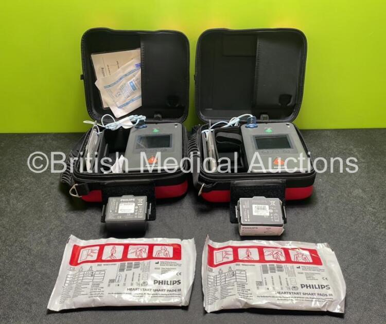 2 x Philips Heartstart FR3 Defibrillators (Both Power Up) In Carry Cases with 2 x Electrode Packs (Both in Date) and 4 x Batteries (Install Before 2028 / 2026 / 2026 / 2023)