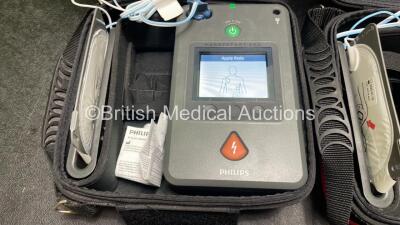 2 x Philips Heartstart FR3 Defibrillators (Both Power Up) In Carry Cases with 2 x Electrode Packs (Both in Date) and 4 x Batteries (Install Before 2028 / 2026 / 2026 / 2023) - 3