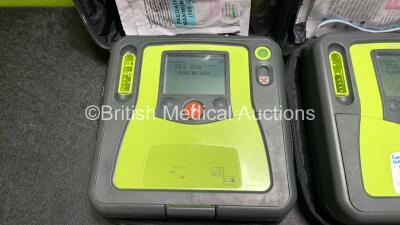 2 x Zoll AED PRO Defibrillators (Both Power Up) with 2 x 3 Lead ECG Leads, 2 x Batteries and 4 x Electrode Packs (2 x in Date, 2 x Expired) - 2