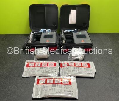 2 x Philips Heartstart FR3 Defibrillators (Both Power Up) In Carry Cases with 3 x Electrode Packs (All in Date) and 4 x Batteries (Install Before 2025 / 2025 / 2025 / 2025)