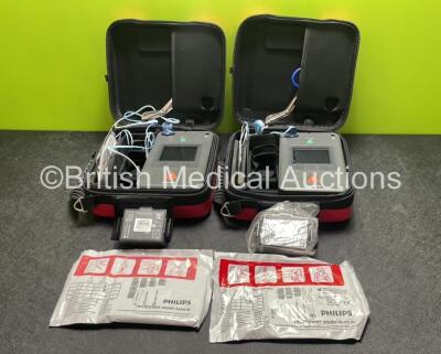 2 x Philips Heartstart FR3 Defibrillators (Both Power Up) In Carry Cases with 2 x Electrode Packs (Both Expired) and 4 x Batteries (Install Before 2025 / 2025 / 2025 / 2022)