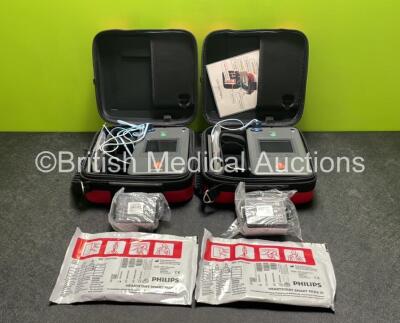 2 x Philips Heartstart FR3 Defibrillators (Both Power Up) In Carry Cases with 2 x Electrode Packs (Both in Date) and 4 x Batteries (Install Before 2027 / 2027 / 2027 / 2022)