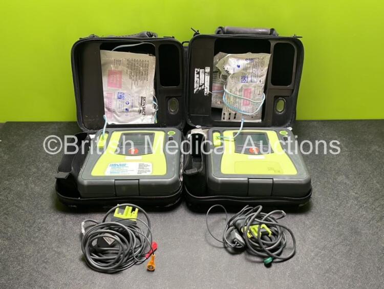 2 x Zoll AED PRO Defibrillators (Both Power Up) with 2 x 3 Lead ECG Leads, 2 x Batteries and 4 x Electrode Packs (3 x in Date, 1 x Expired)