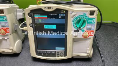 2 x Philips Heartstart MRx Defibrillators / Monitors Including ECG, and Printer Options (Both Power Up) with 1 x 3 Lead ECG Lead, 1 x Philips M3725A Test Load, 2 x Paddle Leads and 2 x Philips M3539A Modules - 2